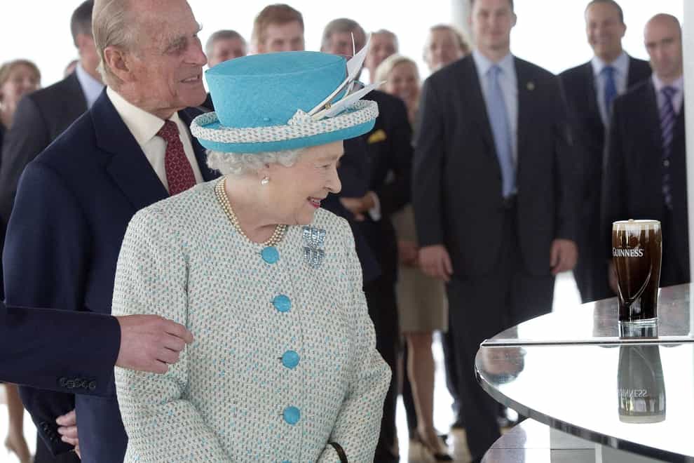 The Queen and the Duke of Edinburgh admire a pint of Guinness at the Guinness Storehouse during the second day of her State Visit to Ireland (Arthur Edwards/The Sun/PA)