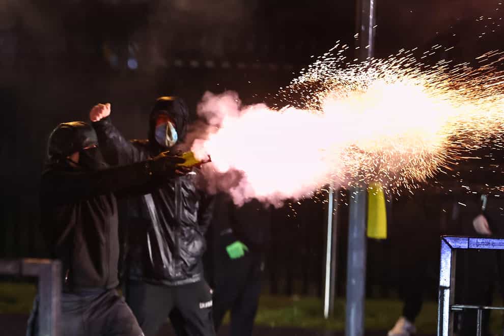 Youths fire fireworks at the PSNI on the Springfield road, during further unrest in Belfast (Liam McBurney/PA)