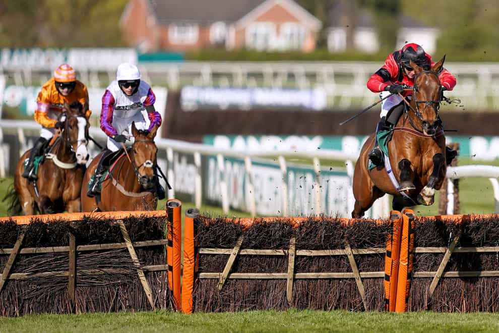 Ahoy Senor ridden by Derek Fox (right) clears a fence on their way to winning the Doom Bar Sefton Novices’ Hurdle during Ladies Day of the 2021 Randox Health Grand National Festival