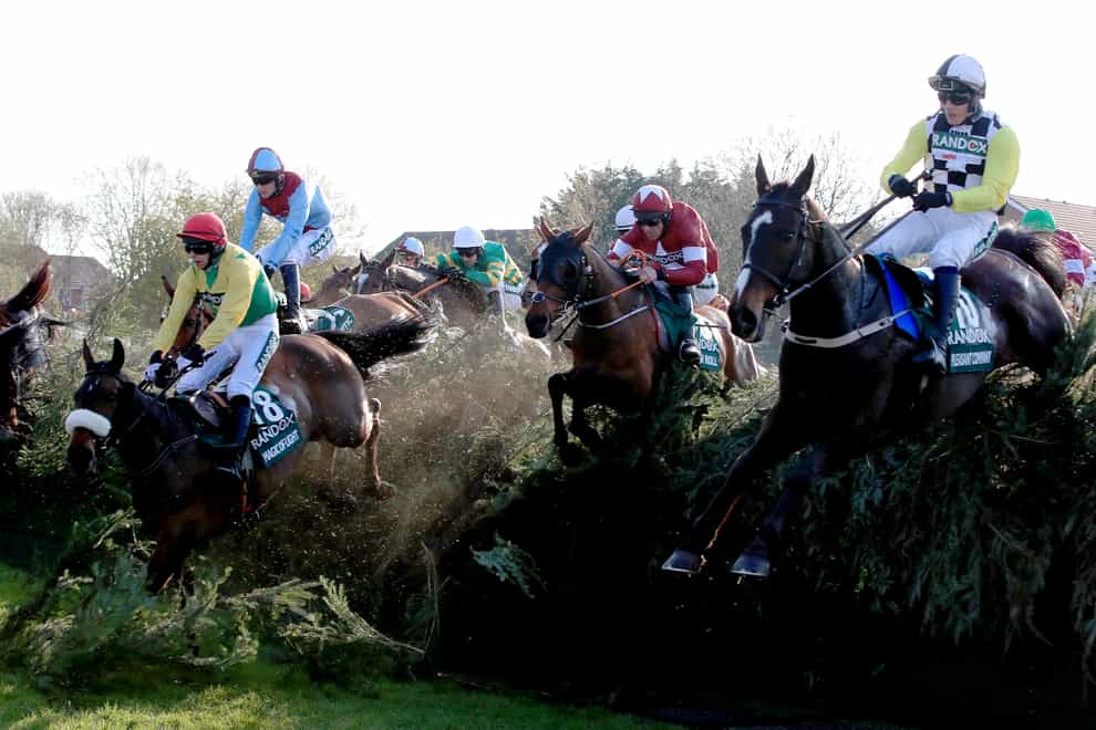 Tiger Roll ridden by jockey Davy Russell (centre) on the way to winning the Randox Health Grand National in 2019