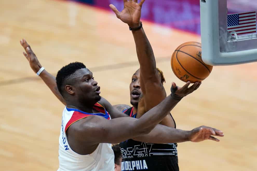 New Orleans Pelicans forward Zion Williamson drives to the basket against Philadelphia 76ers center Dwight Howard