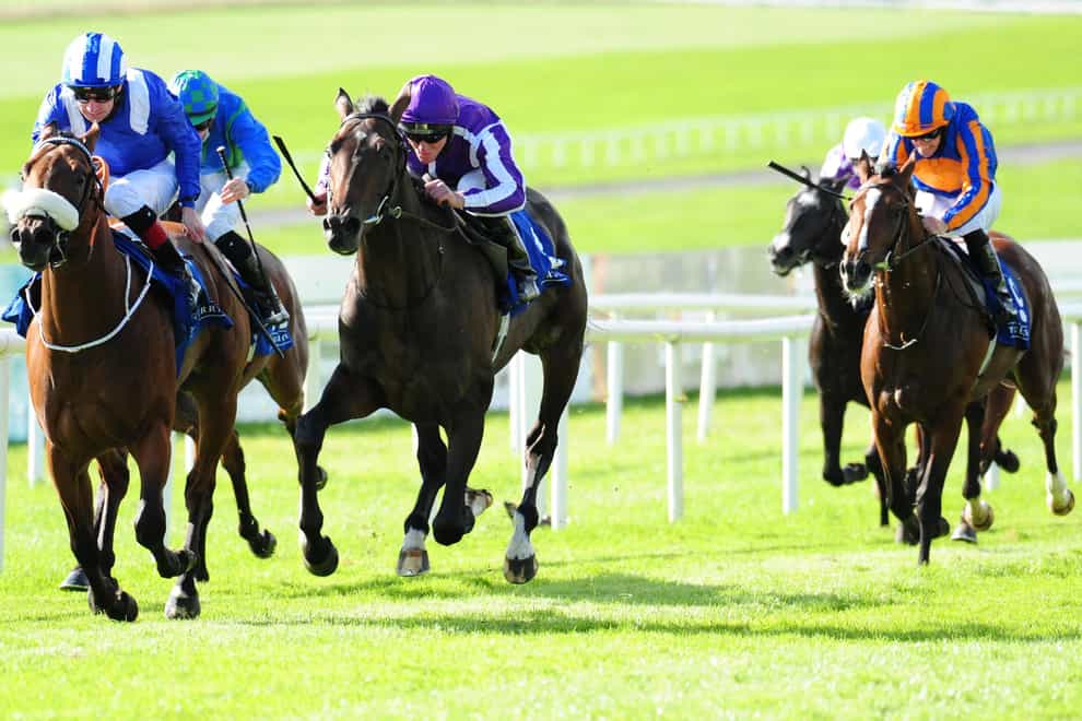Monaasib (left) leads High Definition (centre) in the Beresford Stakes