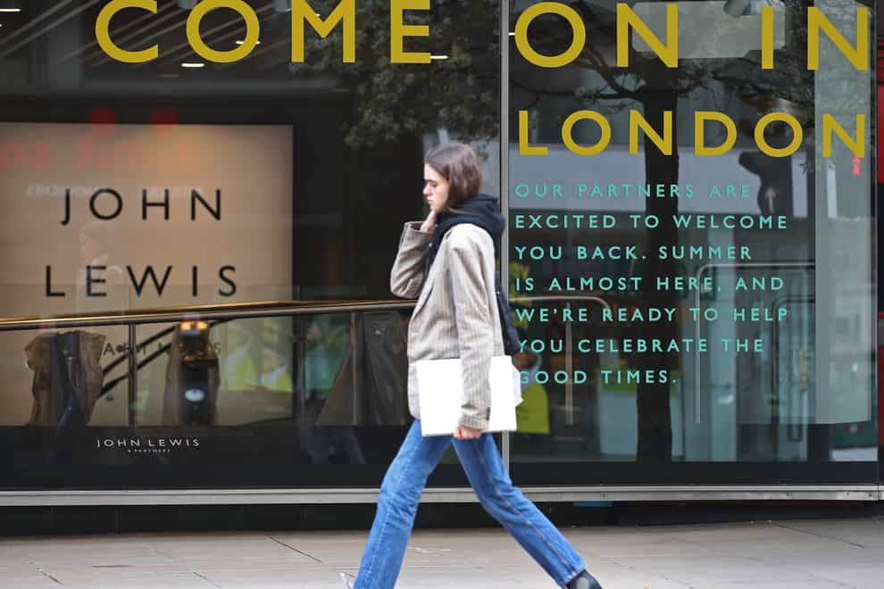 A 'Come on in' sign in the window of a John Lewis store