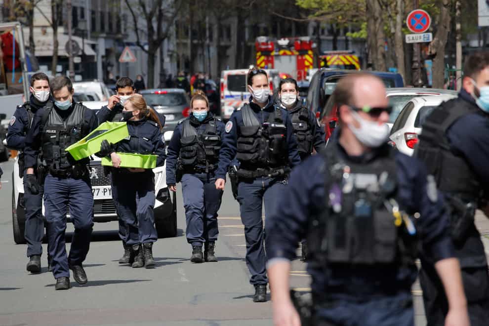 Police officers leave the scene after a shooting in Paris