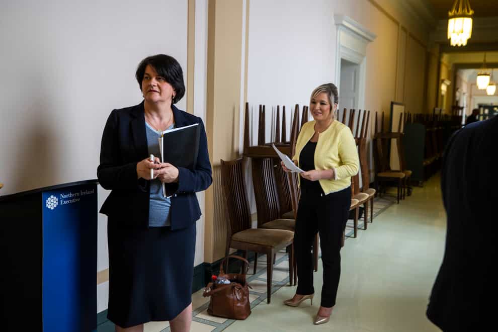 First Minster Arlene Foster (left), and deputy First Minister Michelle O’Neill in the hallway together before a Northern Ireland Executive press conference (PA)