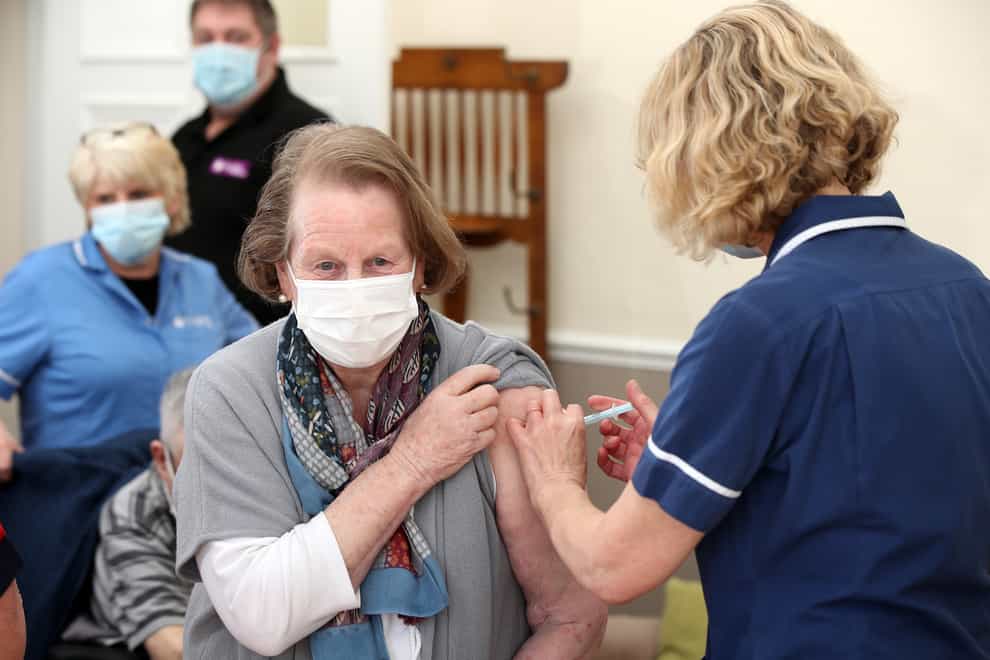 A woman receives a coronavirus jab