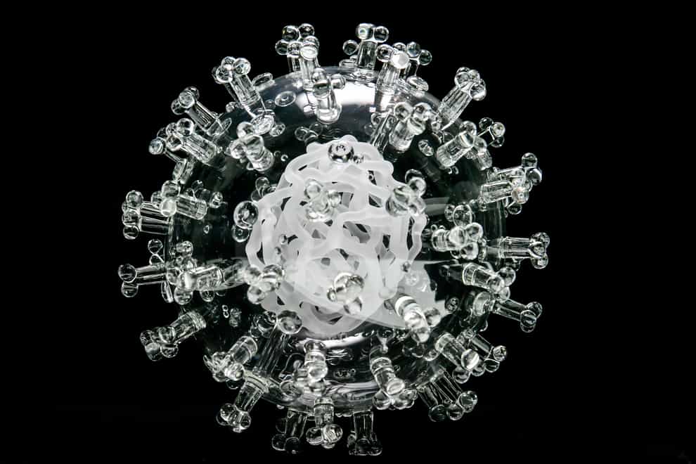 A glass sculpture of the coronavirus