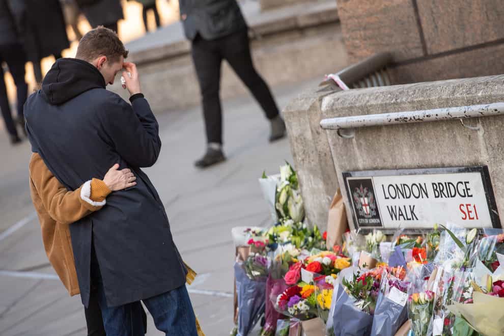 People lay flowers at London Bridge for the victims of the London Bridge terrorist attack