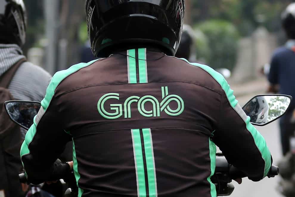 A GrabBike driver rides on his motorbike in Jakarta, Indonesia