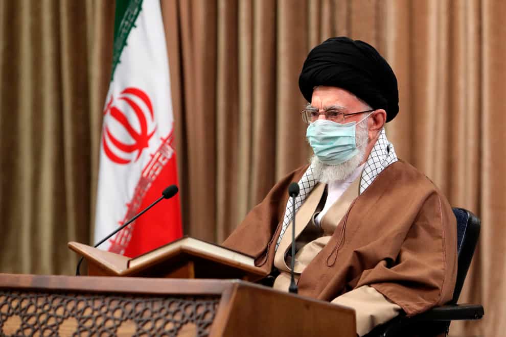 Supreme Leader Ayatollah Ali Khamenei wearing a protective face mask, attends a meeting in Tehran, Iran