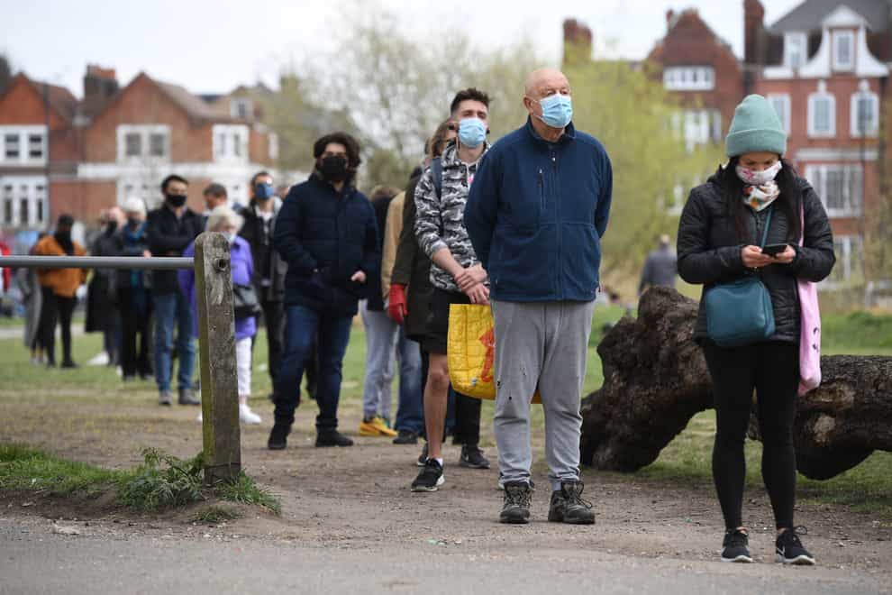 People stand in line for coronavirus surge testing on Clapham Common, south London (Kirsty O'Connor/PA)