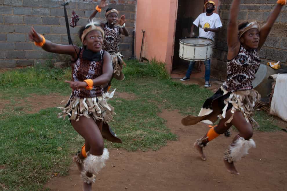 A group of girls perform a traditional Zulu dance (Denis Farrell/PA)