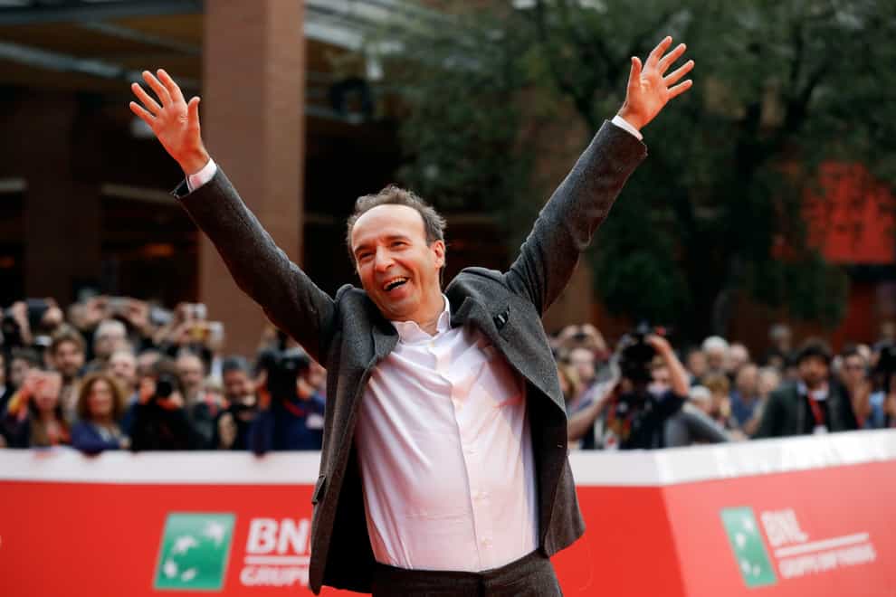 Roberto Benigni poses for photographers as he arrives on the red carpet at the Rome Film Festival (Gregorio Borgia/AP)