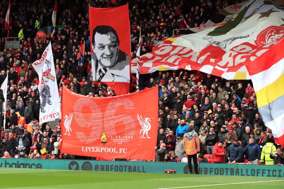 A banner adorned with the number 96 is waved at Anfield