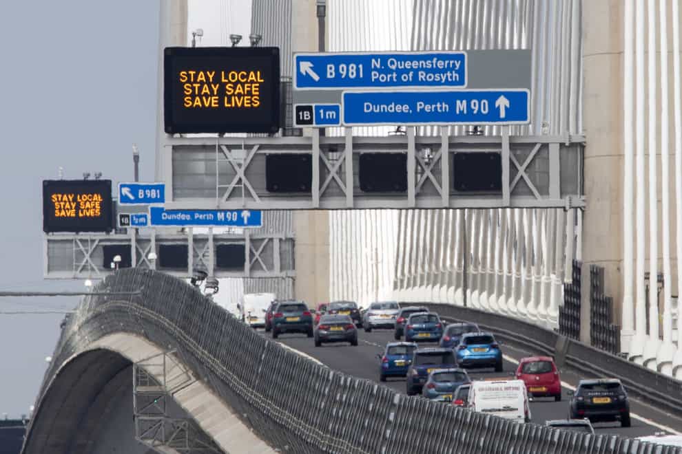 Traffic information signs read 'Stay Local, Stay Safe, Save Lives' above the M90 on the Queensferry Crossing near Edinburgh following the easing of Scotland’s lockdown restrictions to allow far greater freedom outdoors (Jane Barlow/PA)