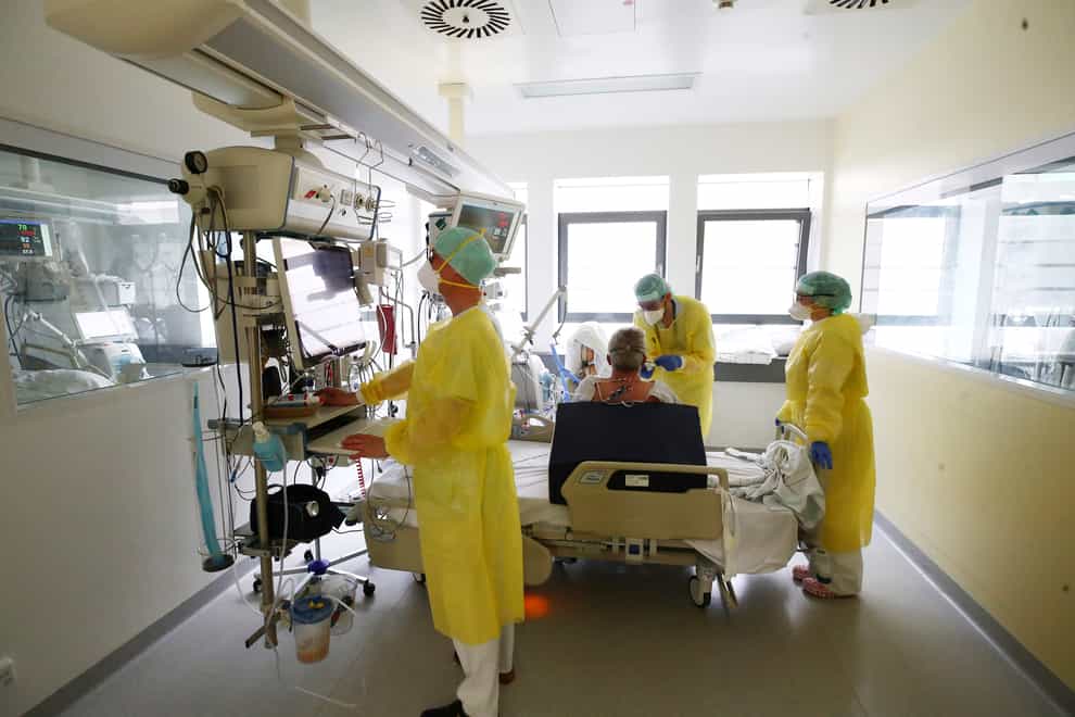 Medical personnel wearing protective equipment work in the intensive care ward for Covid-19 patients at the SRH Waldklinikum hospital in Gera, Germany (Bodo Schackow/AP)