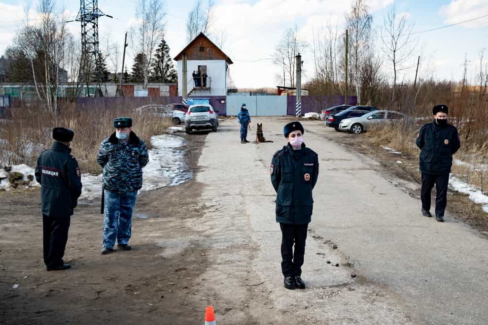 Police officers wearing face masks to protect against coronavirus guard an entrance of the prison colony IK-2, where Alexei Navalny was detained (Pavel Golovkin/AP)