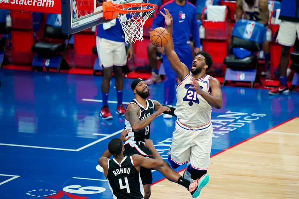 Joel Embiid, right, poured in 36 points and had 14 rebounds