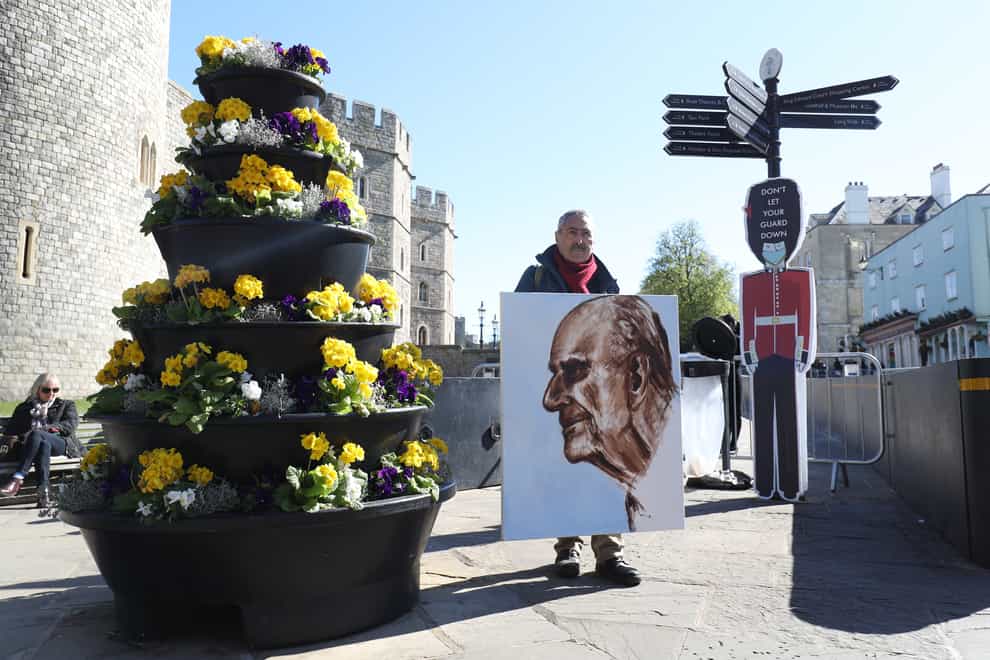 Artist Kaya Mar with a portrait of the Duke of Edinburgh, outside Windsor Castle, on the morning of the funeral (Andrew Matthews/PA)