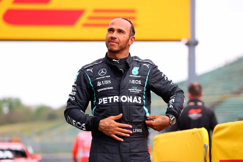 Mercedes driver Lewis Hamilton smiles after taking pole position