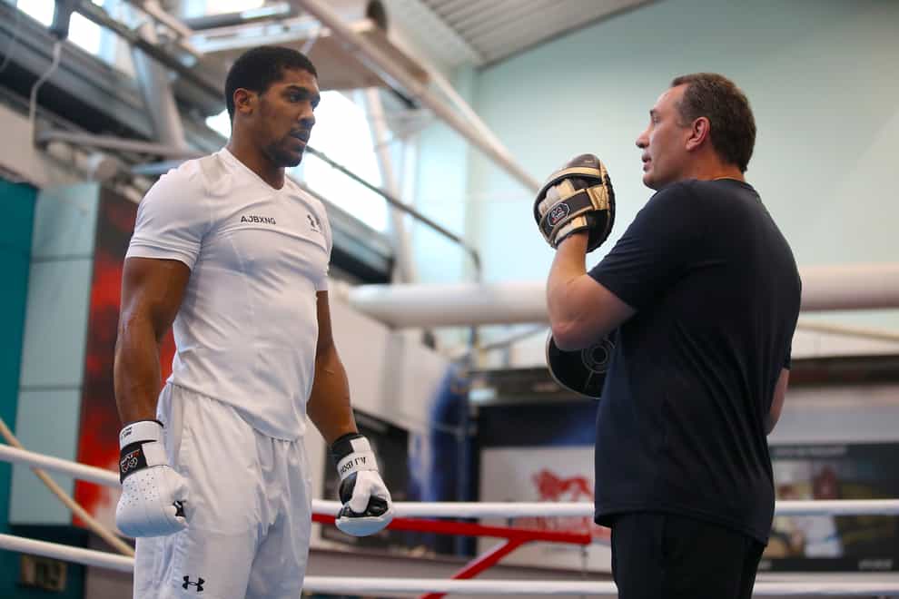 Anthony Joshua, left, might have to face Tyson Fury without Rob McCracken in his corner (Nick Potts/PA)
