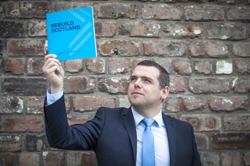 Douglas Ross holding up the 2021 Tory manifesto