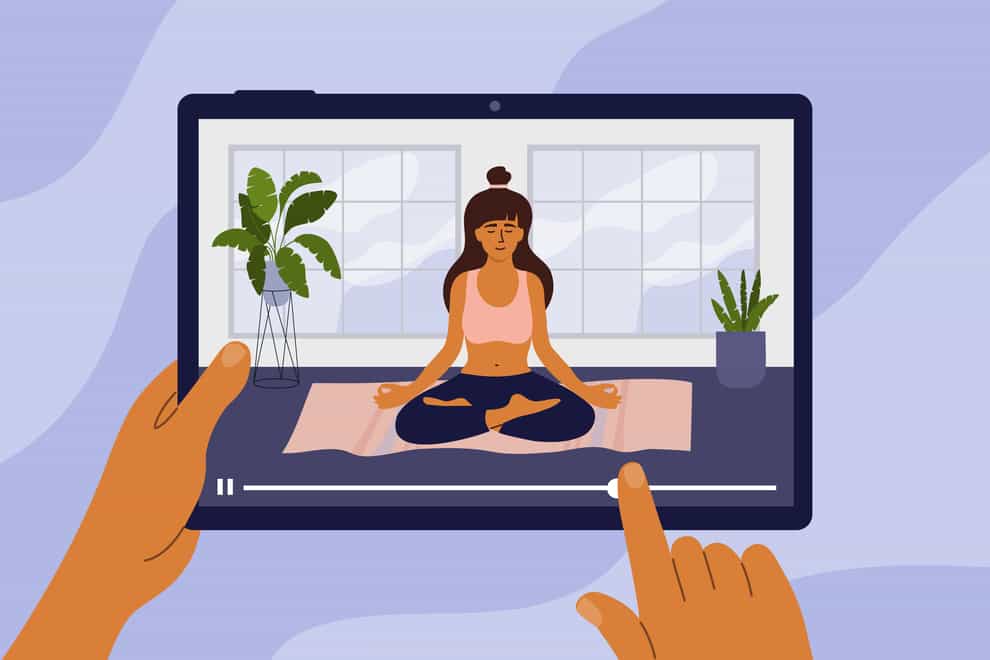 Digital tablet with online studying yoga class on screen