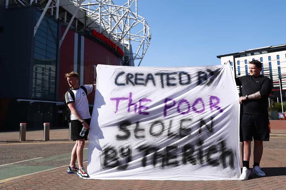 Football fans opposing the European Super League proposals outside Old Trafford in Manchester (Tim Markland/PA)