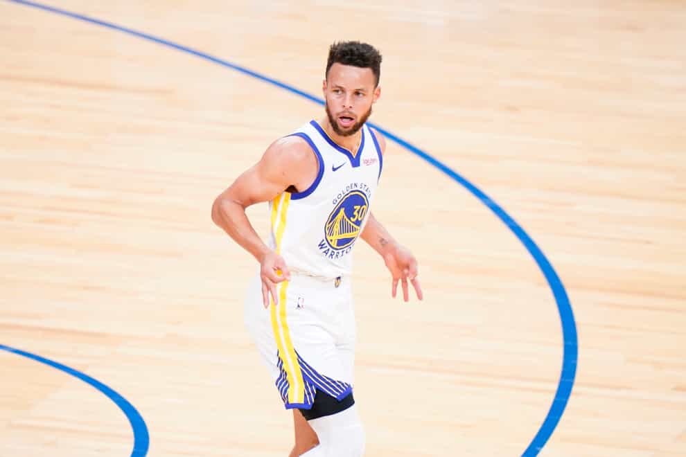 Golden State Warriors’ Steph Curry reacts after making a three-pointer during the first half against the Philadelphia 76ers