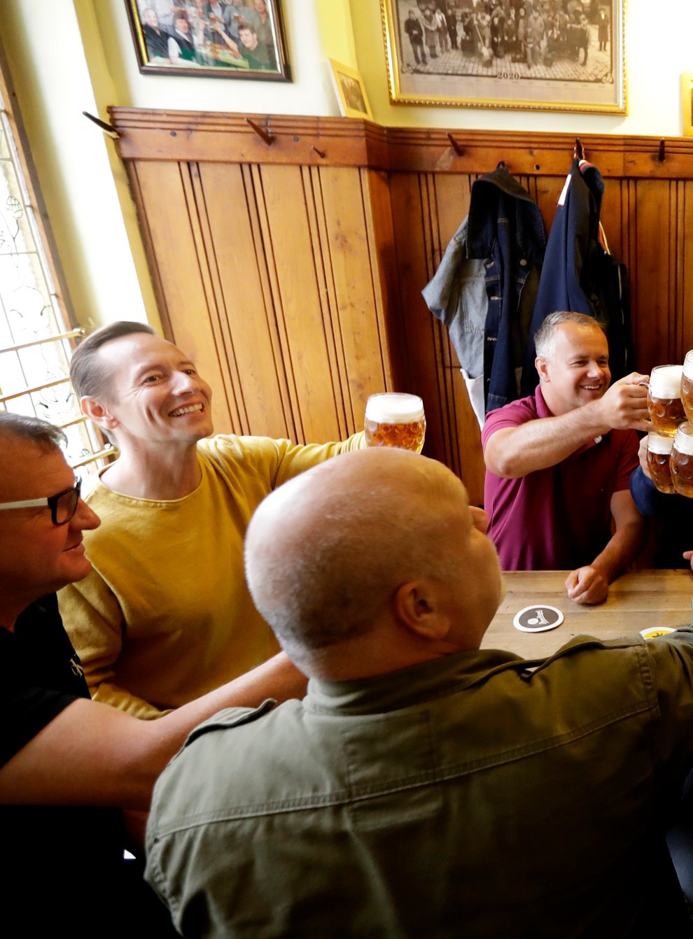 Customers cheer with beer at a pub in Prague, Czech Republic
