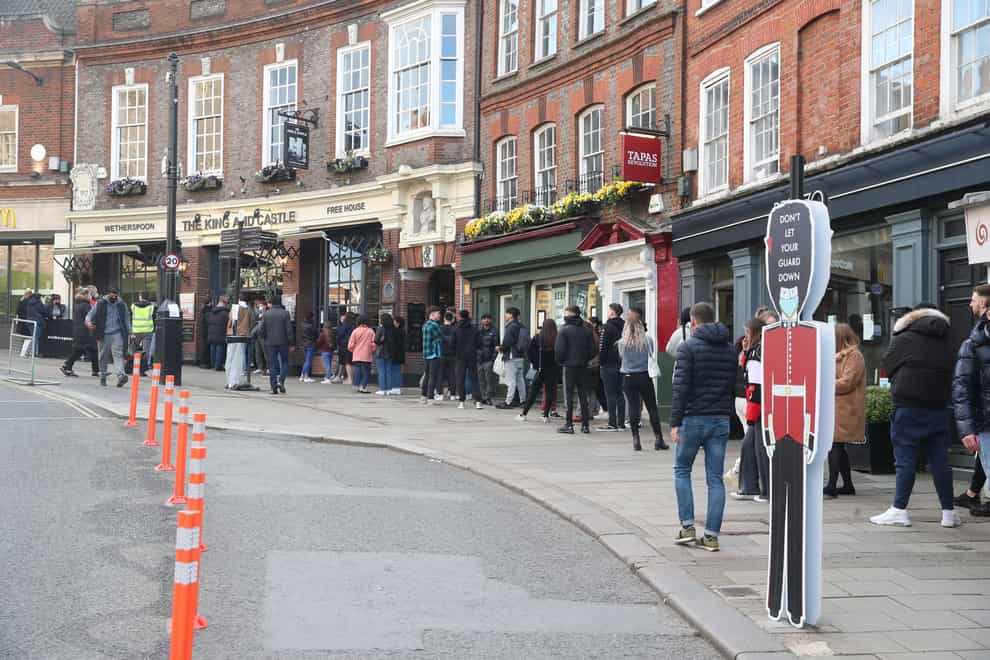 People queue outside the Wetherspoon’s King and Castle pub in Windsor
