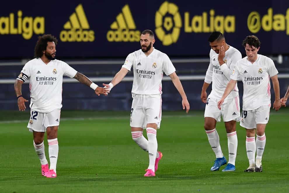 Real Madrid’s Karim Benzema (second left) celebrates after scoring against Cadiz