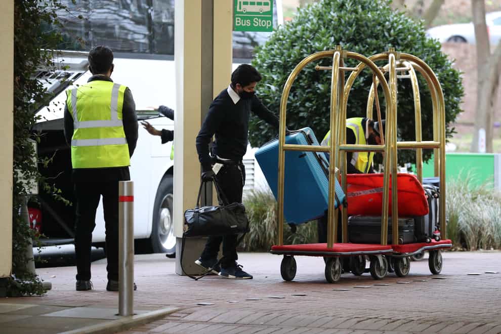 Hotel staff load the luggage of passengers entering quarantine onto trolleys outside the Holiday Inn hotel, near Heathrow Airport