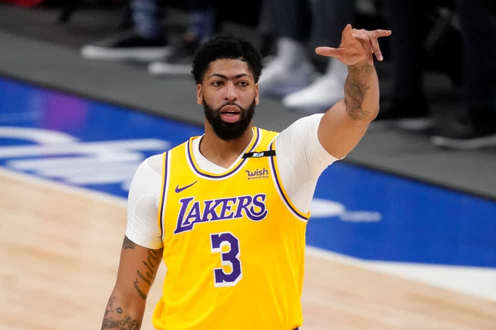 Anthony Davis gestures in front of his body with his left arm outstretched