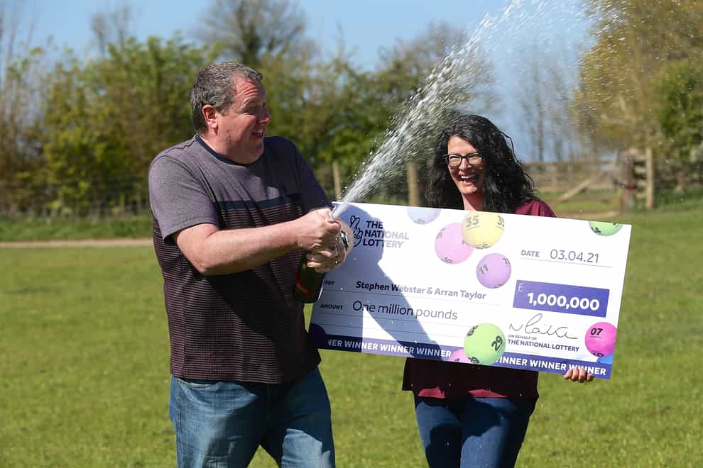 Stephen Webster and partner Arran Taylor celebrate his £1 million Lotto win (The National Lottery/PA).