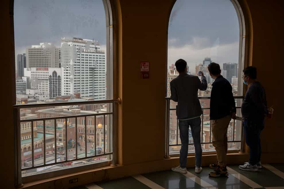Visitors look at the Urumqi skyline from an observation tower at the International Grand Bazaar in Urumqi in western China’s Xinjiang Uighur Autonomous Region (Mark Schiefelbein/AP)