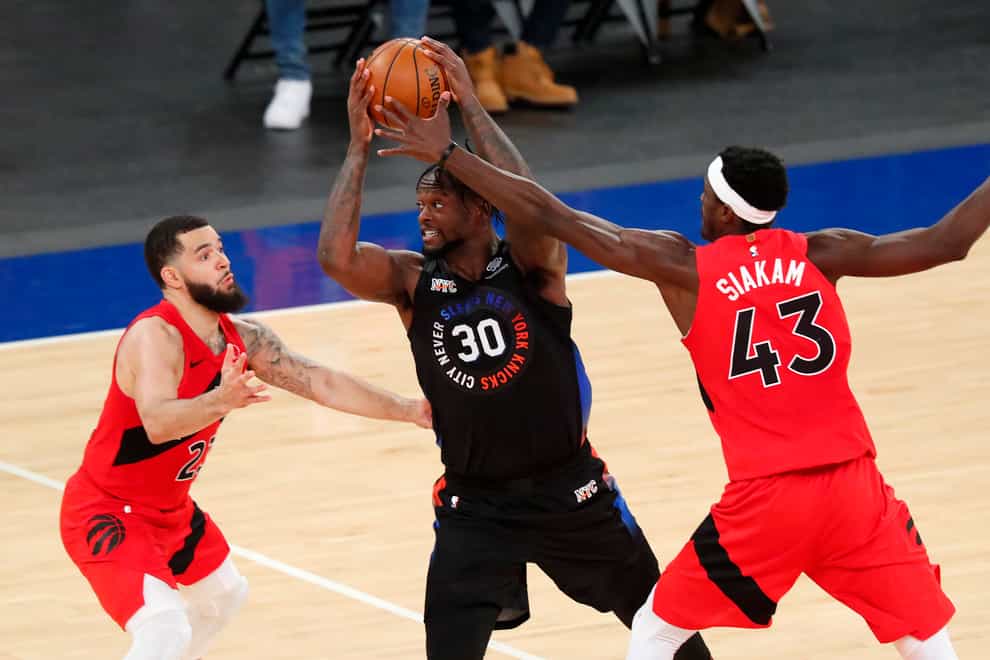 Toronto Raptors' Fred VanVleet and Pascal Siakam defend against New York Knicks forward Julius Randle