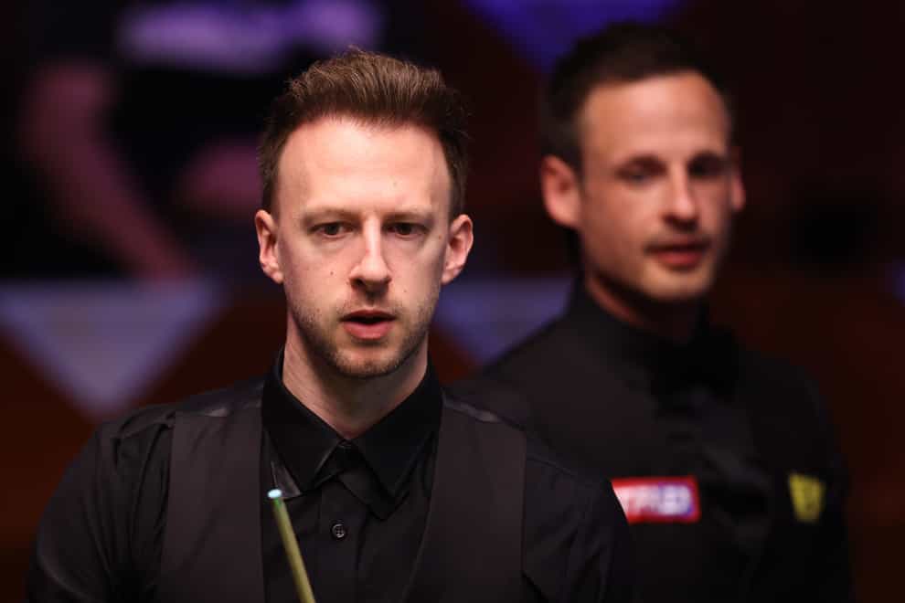Judd Trump looks on in front of David Gilbert during their second-round match at the Betfred World Snooker Championship