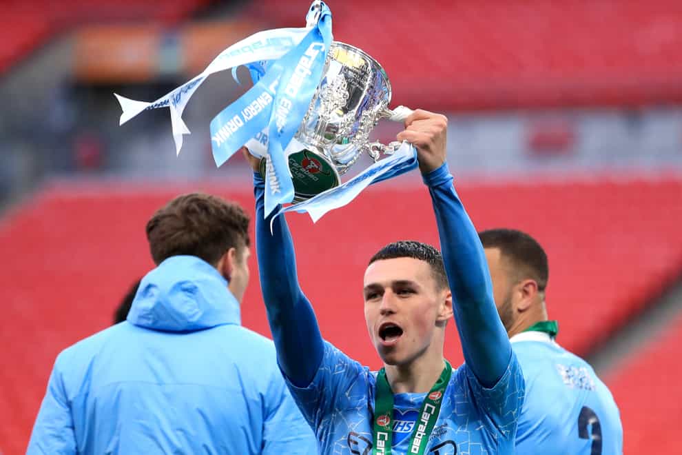 Manchester City’s Phil Foden celebrates with the trophy after collecting a fourth Carabao Cup winners' medal