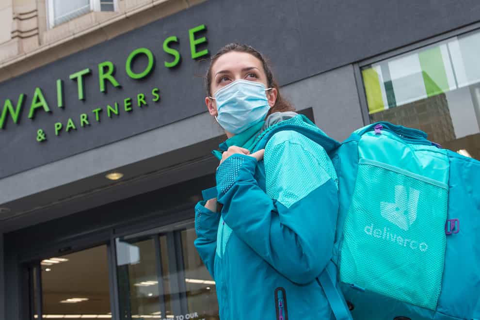 A Deliveroo worker outside a Waitrose store