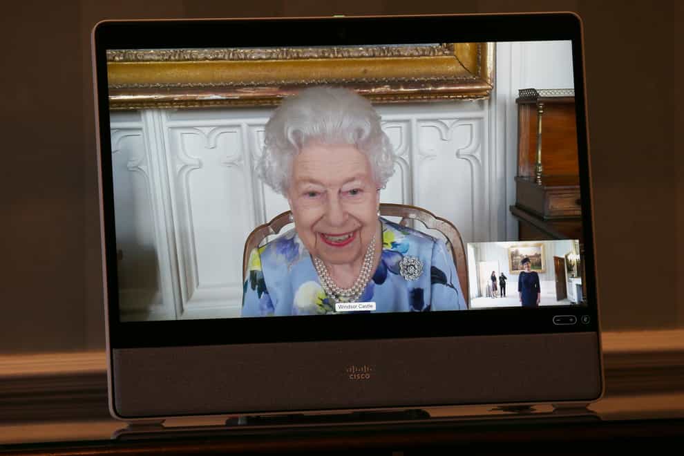 The Queen appears on a screen by videolink from Windsor Castle