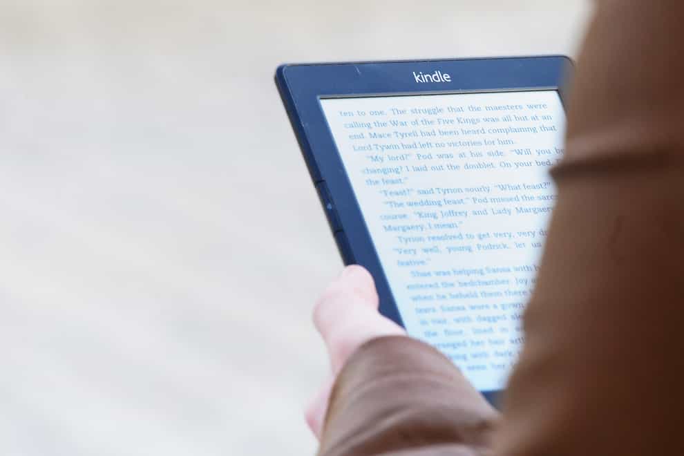A woman reading a Kindle