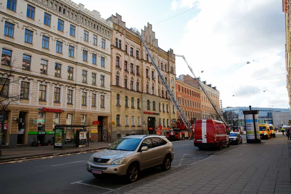 Firefighters and rescuers at the site of the blaze in Riga, Latvia