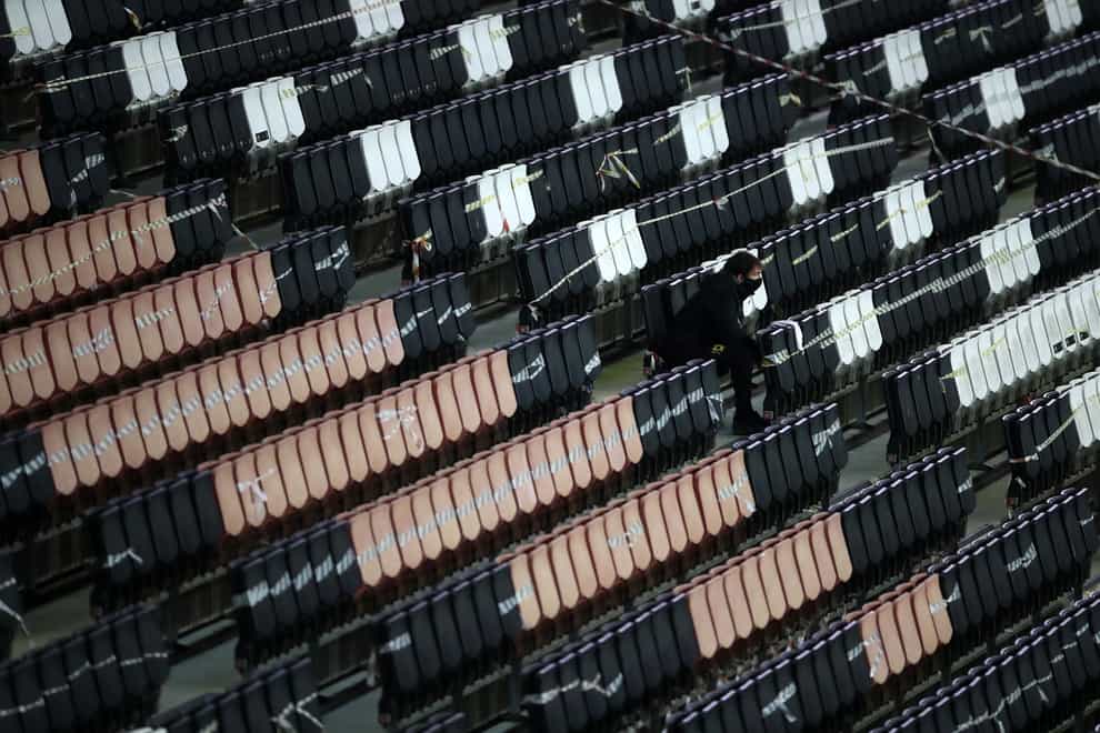 A ball boy watches from the empty stands during MK Dons' Sky Bet League One match against Blackpool