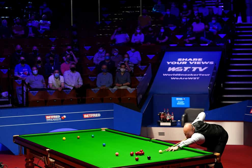 England’s Stuart Bingham plays a shot watched by fans inside The Crucible