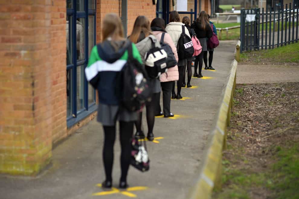 File photo of pupils queuing to take a lateral flow test at Archway School in Stroud in Gloucestershire (Ben Birchall/PA)