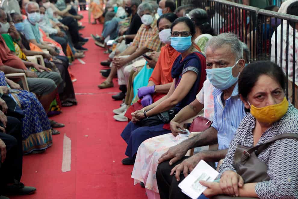 People wait to receive the Covid-19 vaccine in Mumbai, India (Rajanish Kakade/AP)