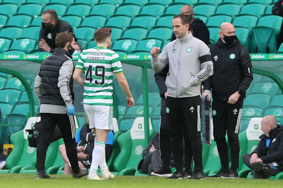 John Kennedy, centre right, greets James Forrest as he is substituted after an injury against Livingston