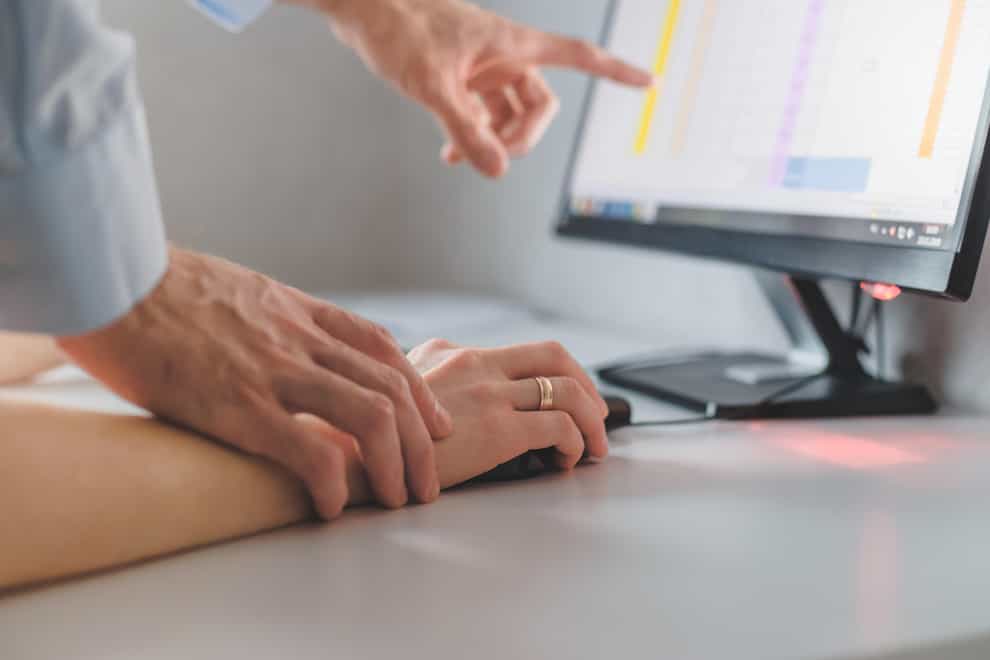 Man touching woman's hand while working