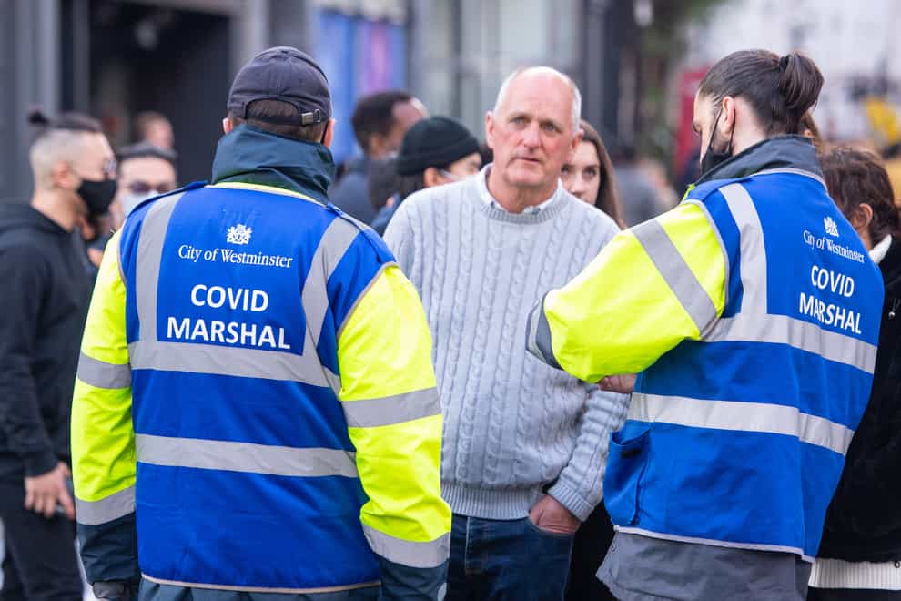 Covid marshals speak to members of the public in Soho, central London (Dominic Lipinski/PA)